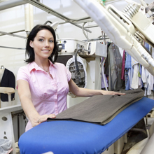 Dry Cleaner Placing a Shirt on an Iron Board